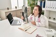 © Krakenimages.com - Down syndrome woman wearing doctor uniform holding x-ray at clinic