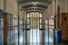 Blue Metal Lockers Along A Nondescript Hallway, With Windows, In A Typical US High School. No Identifiable Information Included And Nobody In The Hall.	