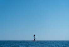 Navigation Buoy Or Small Beacon On Tiny Island In The Calm Blue Sea.
