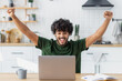 © kucherav - Excited young man reading good news using laptop, winning lottery game. Happy Indian male receives online gift feeling joy