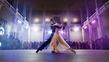 Couple dancers perform waltz on large professional stage. Ballroom dancing.