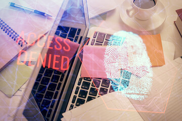 Poster - Finger print over computer on the desktop background. Top view. Double exposure. Concept of securitization.