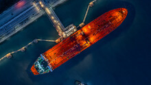 Aerial Top View Industrial Crude Oil Fuel Tanker Ship At Terminal Industrial Port,  Tanker Ship Unloading Crude Oil, Industry Refinery Fuel Chemical Import Export Business Logistic And Transportation.