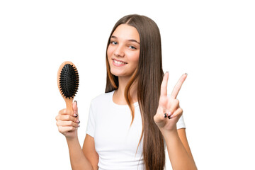 Sticker - Teenager caucasian girl with hair comb over isolated background smiling and showing victory sign