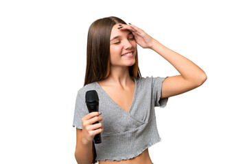 Sticker - Teenager singer girl picking up a microphone over isolated background smiling a lot