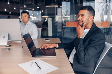 Wall Mural - Two multiracial business people working in modern coworking