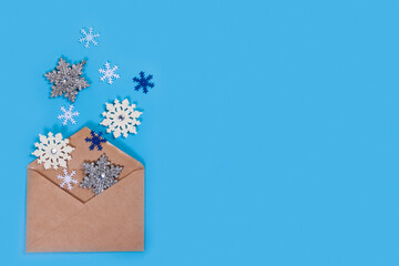 Wall Mural - Christmas composition. Christmas decorations and envelope on blue background.