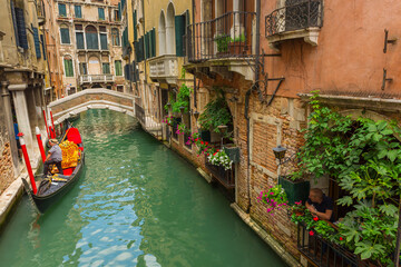 Tourists travel on gondolas at canal