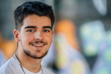 portrait of millennial young man with beard looking at camera