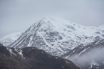 Wall Mural - Beautiful Winter landscape image of snowcapped peak of Stob Dearg Buachaille Etive Mor in Glencoe, Rannoch Moor