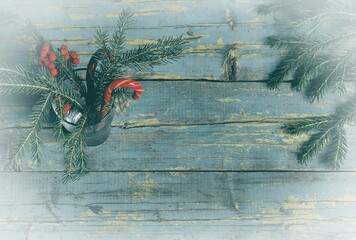 Wall Mural - Artwork winter fog.On an ancient wooden background stands a glass with fir branches, caramel cane.Christmas greeting background.Merry Christmas and Happy New Year.