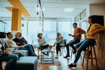 Young designer giving some new ideas about project to his partners in conference room. Business people discussing over new business project in office.