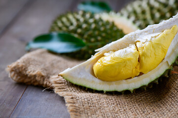 Wall Mural - Puangmanee durian on wood plate and wood background, It's a small durian. v