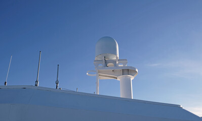 VSAT terminal, satellite internet connection, navigation equipment installed on the ship's superstructure. Telecommunications and Navigation equipment on the upper decks of a modern cruise ship.