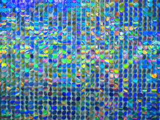 Poster - Wall is decorated with round plates. Iridescent background. Colorful texture. Multicolored pattern. Blue plates shimmer in different colors. Background for decoration. Abstract multicolored texture