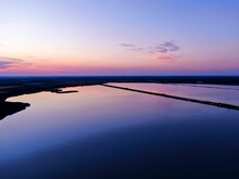 High-angle Shot Of The Pink Evening Sky Reflecting Off Lake Water - Great For Nature Backgrounds