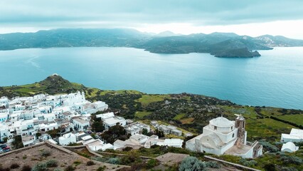 Canvas Print - Aerial of white buildings of Milos overlooking the sea in Greece.