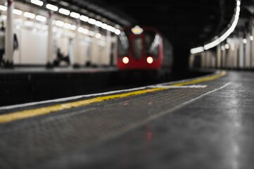 Poster - Blurry low angle shot of a red train in a station in london