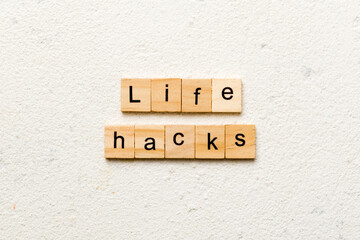 life hacks word written on wood block. life hacks text on table, concept