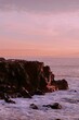 Vertical of rock formation in the sea at sunset - great for background