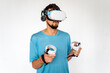 © thomsond - Young man using virtual reality headset on light background