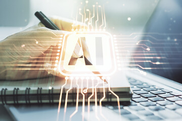 Poster - Creative artificial Intelligence symbol concept with hand writing in notebook on background with laptop. Multiexposure