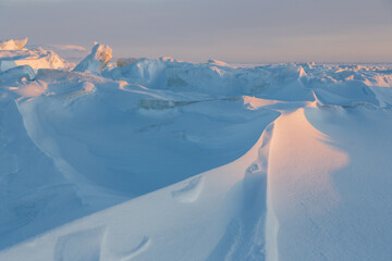 Wall Mural - winter arctic landscape. ice hummocks on the frozen sea in the arctic. view of snow and ice at sunse