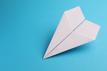 Sticker - Handmade white paper plane on light blue background, space for text