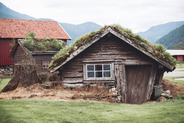 Norway, traditional houses in the mountains with grass on the roof.