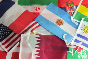 leather soccer ball with international team flags of the participating countries in the championship