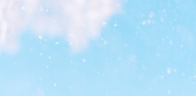 Background Of Falling Snow Against The Blue Sky.