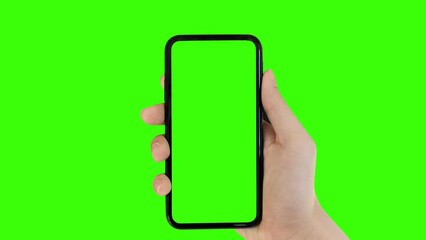 Business man hand shows mobile smartphone with green screen on green background.	