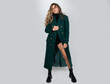 Fashion female coat. Vogue model posing at studio. Collection of fashion clothes, full length.