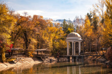 White Rotunda In Beautiful Autumn Park Amidagainst The Background Of Mountains. 