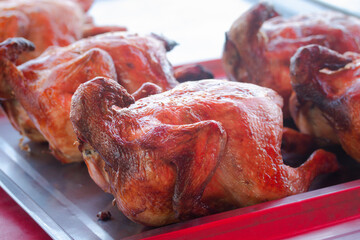 Poster - Whole roasted chicken is placed in a tray.