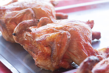 Poster - Whole roasted chicken is placed in a tray.