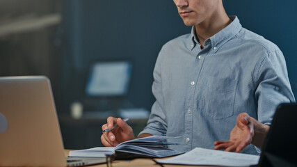 Wall Mural - young man using a digital tablet and laptop .