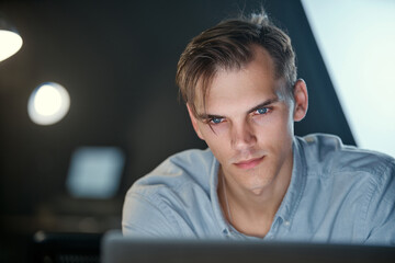 Wall Mural - serious young man working on a laptop .