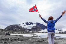 Woman Holds Norwegian Flag In Mountains Norway