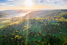 Germany, Baden-Wurttemberg, Drone View Of Sun Rising Over Autumn Landscape Of Remstal Valley