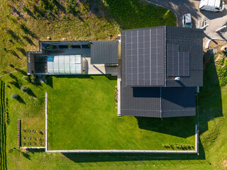 Fototapete - Top view of solar photovoltaic panels on roof, alternative energy, saving resources and sustainable lifestyle concept.