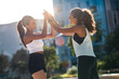 © Westend61 - Cheerful friends giving high-five to each other on sunny day