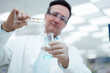 © Westend61 - Chemist pouring solution from test tube to flask in laboratory