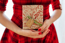 Woman In Red Dress Holding Christmas Gift