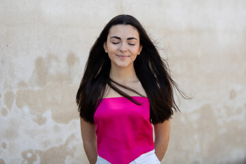 Sticker - Portrait of a happy lovely and beautiful Spanish young woman in a park.