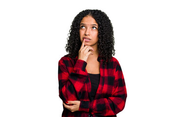 Wall Mural - Young cute brazilian woman isolated looking sideways with doubtful and skeptical expression.