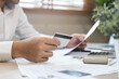 © Pormezz - A stressed person worried about credit card debt.