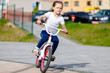 © Ruslan Ivantsov - Little girl on a bicycle in summer park. cycling outdoors