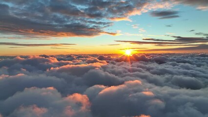 Wall Mural - Epic sunset over the clouds. Warm sun sets over the horizon in clouds. Flight in the sky at sunset, view from window of airplane. UHD, 4K