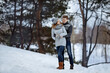 © Kaplitskaya Love - The couple hugs and smiles while standing in the snow.